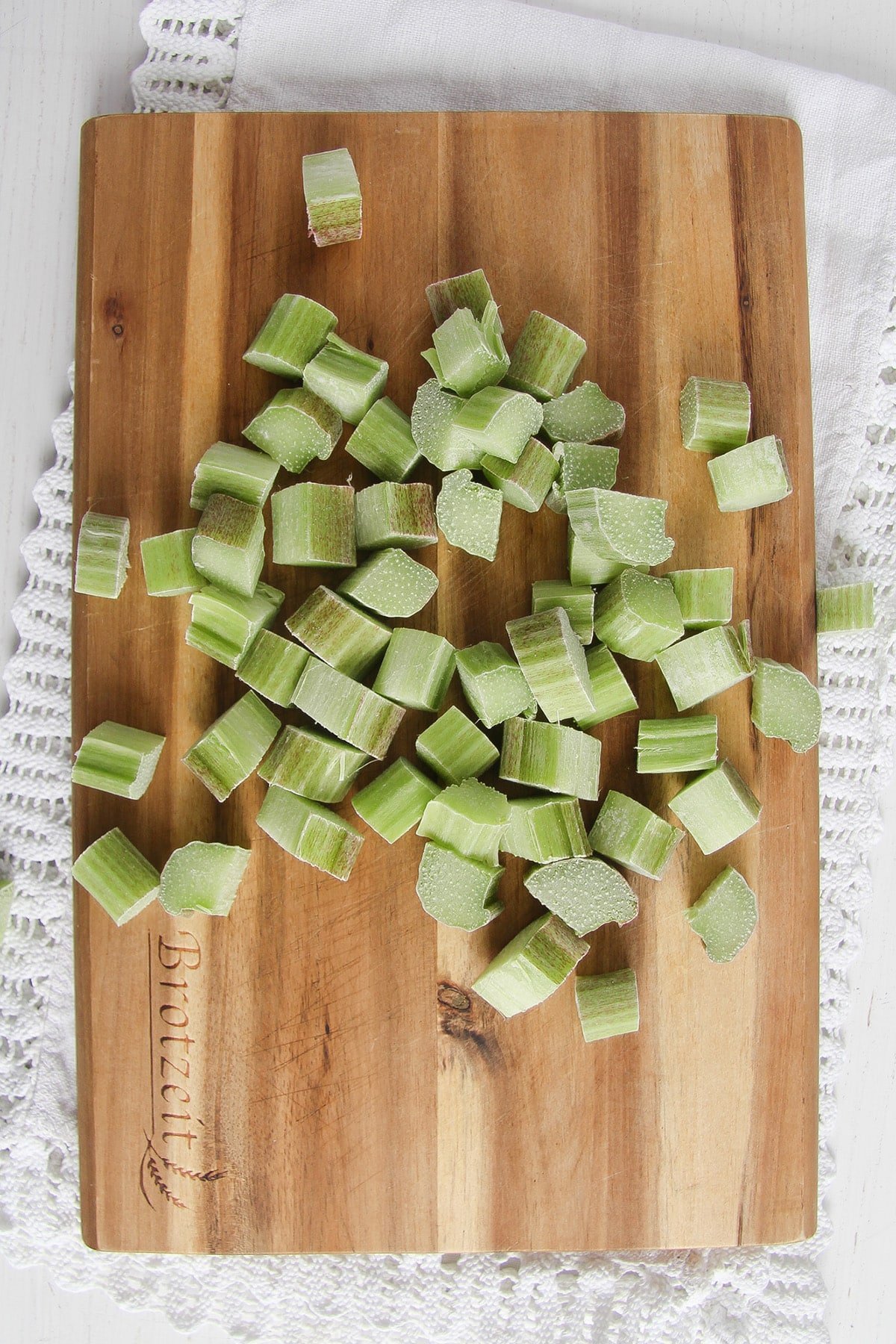 chopped rhubarb on a wooden cutting board.