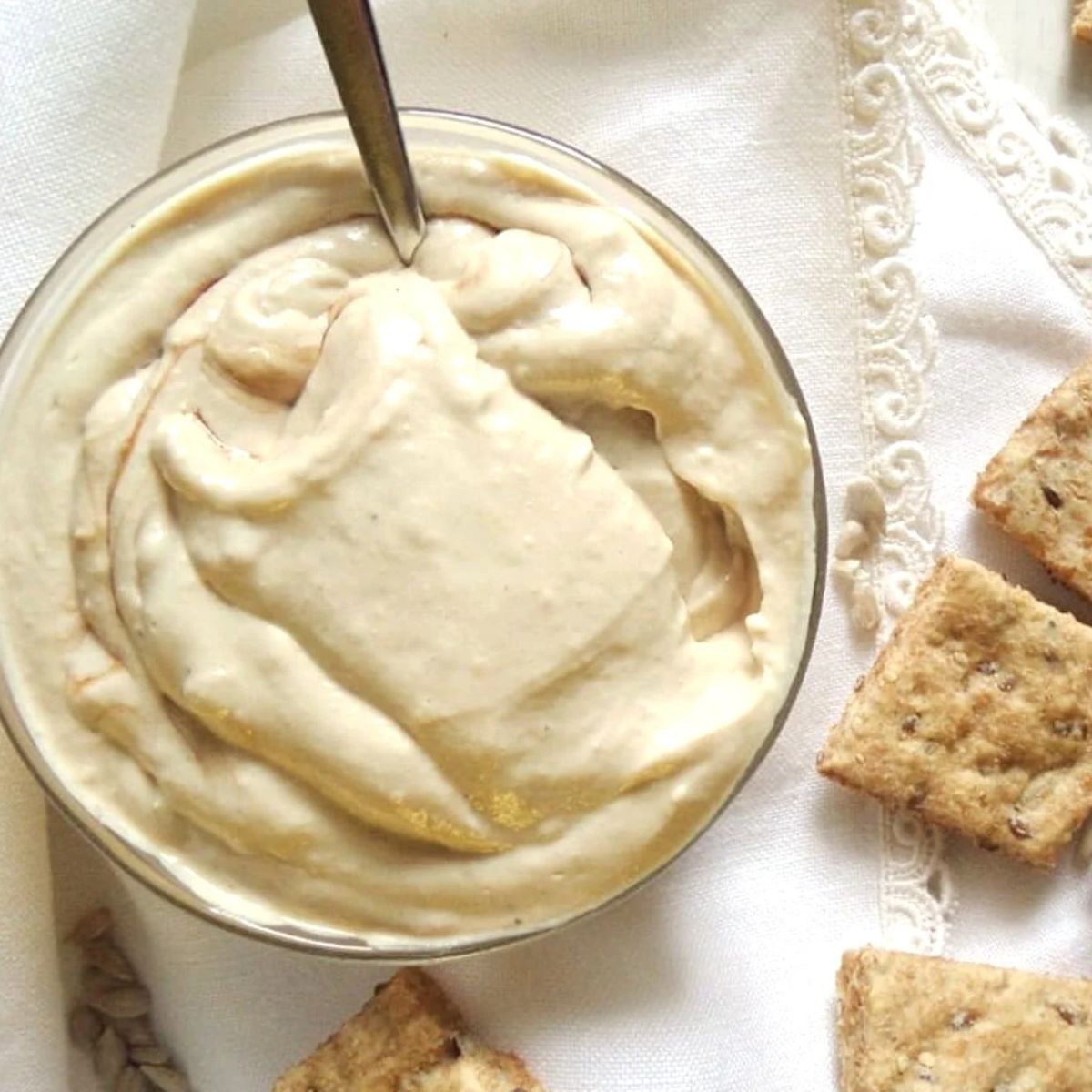 silken tofu spread or dip in a small bowl with crackers around it.