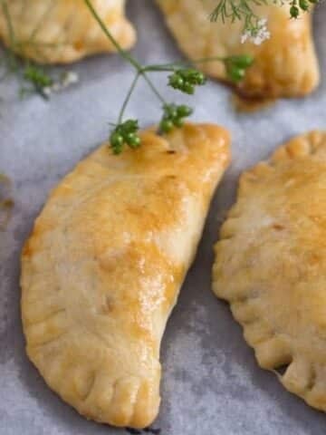 a few spicy beef empanadas with golden crust.