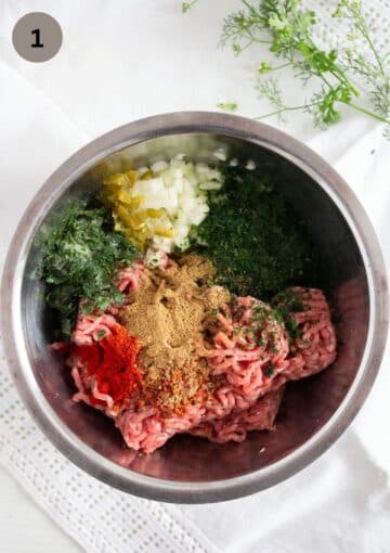 beef, herbs and spices in a bowl to make empanada filling.