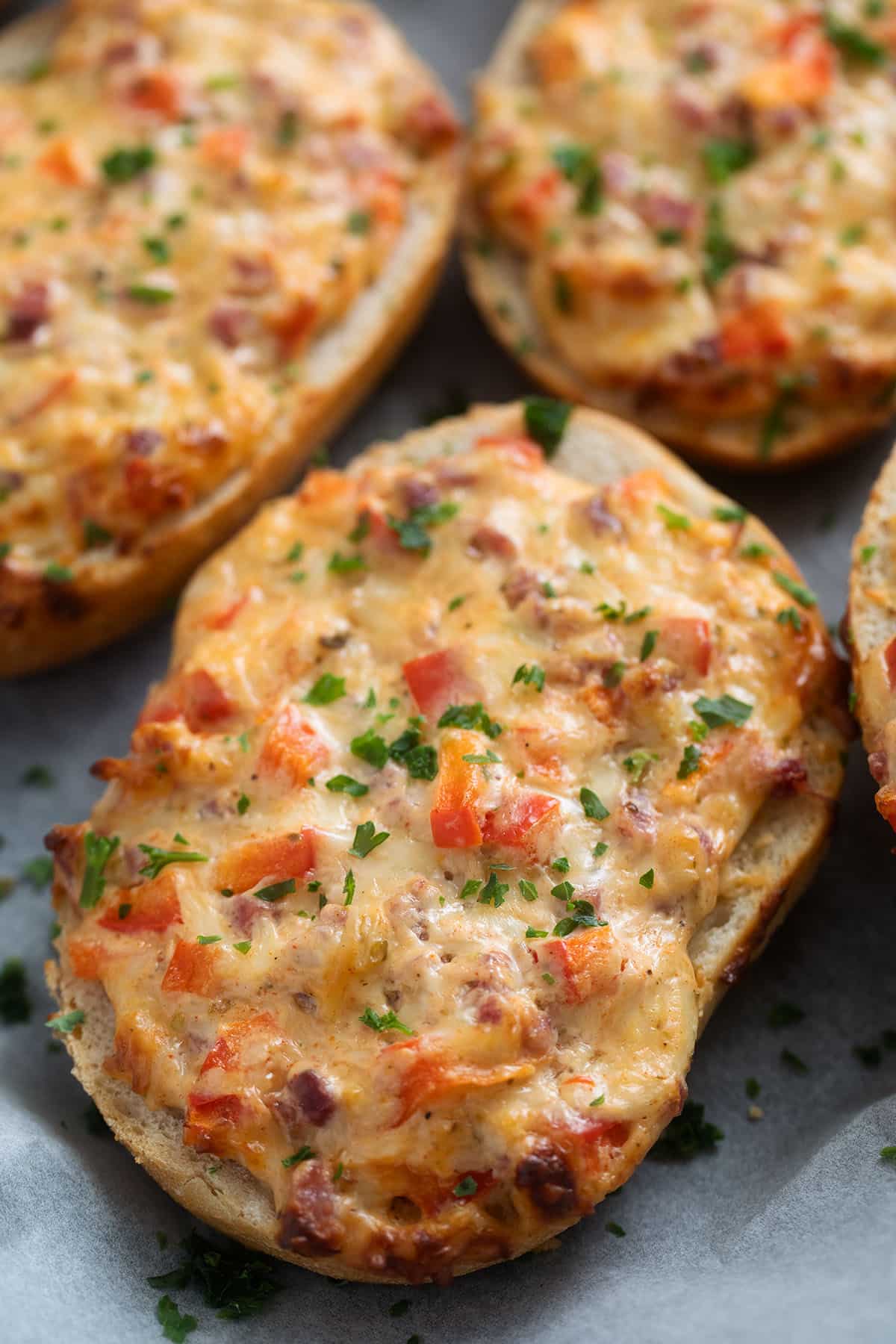 one crispy bread roll topped with cheese and baked.