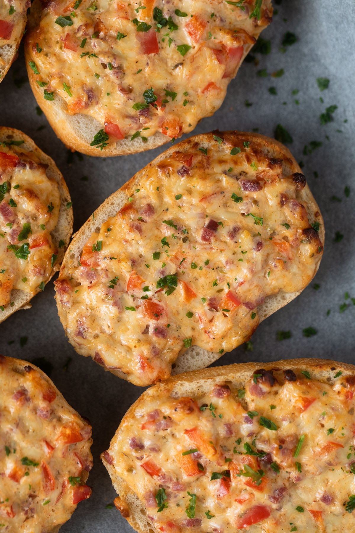 stuffed bread rolls with ham and cheese sprinkled with parsley. 