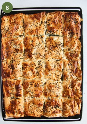 baked turkish pie with spinach in a large baking tray.