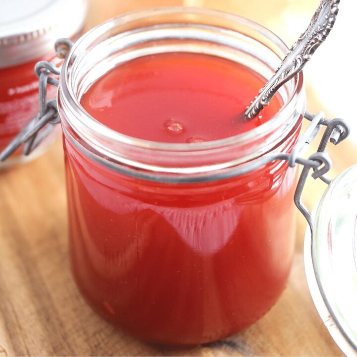 watermelon jam in a jar with a spoon in it