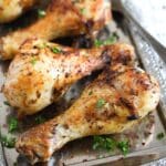 air fryer chicken legs with spices on a silver platter.