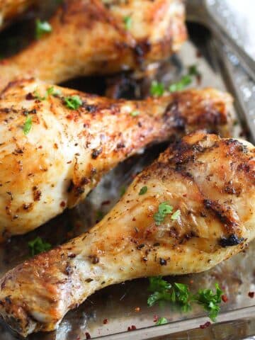 air fryer chicken legs with spices on a silver platter