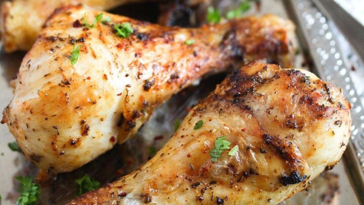 air fryer chicken legs with spices on a silver platter.