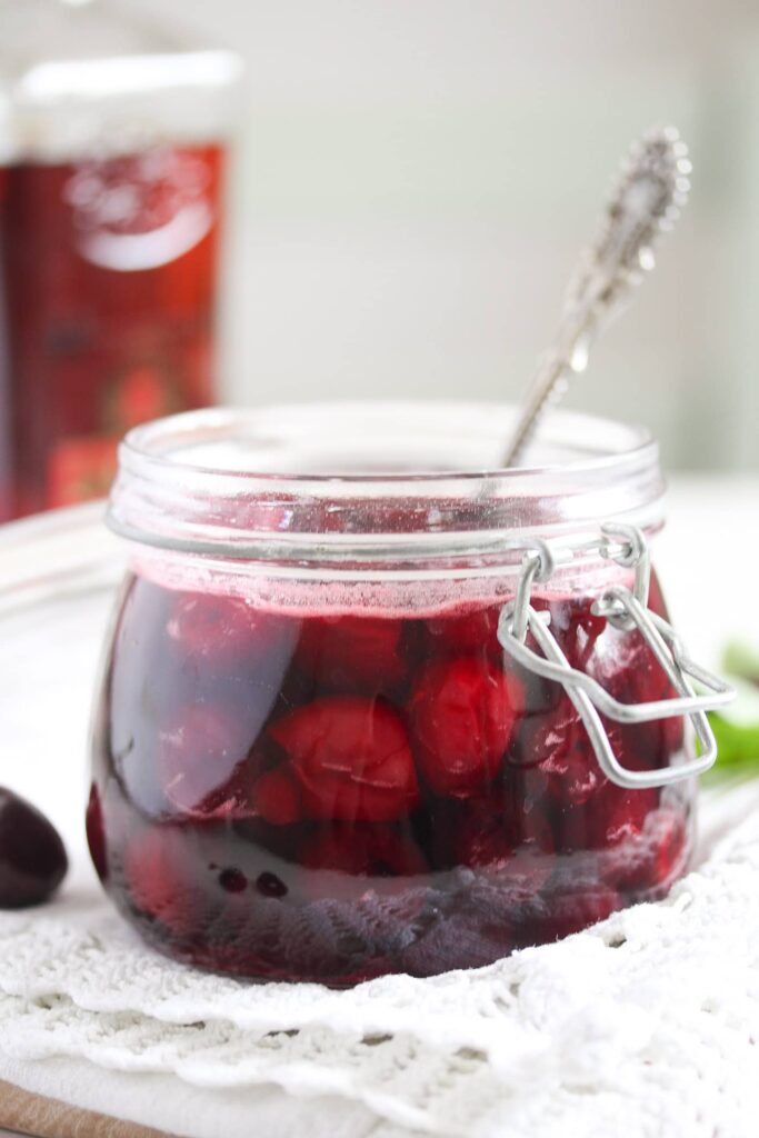 amaretto cherries in a jar with a vintage spoon