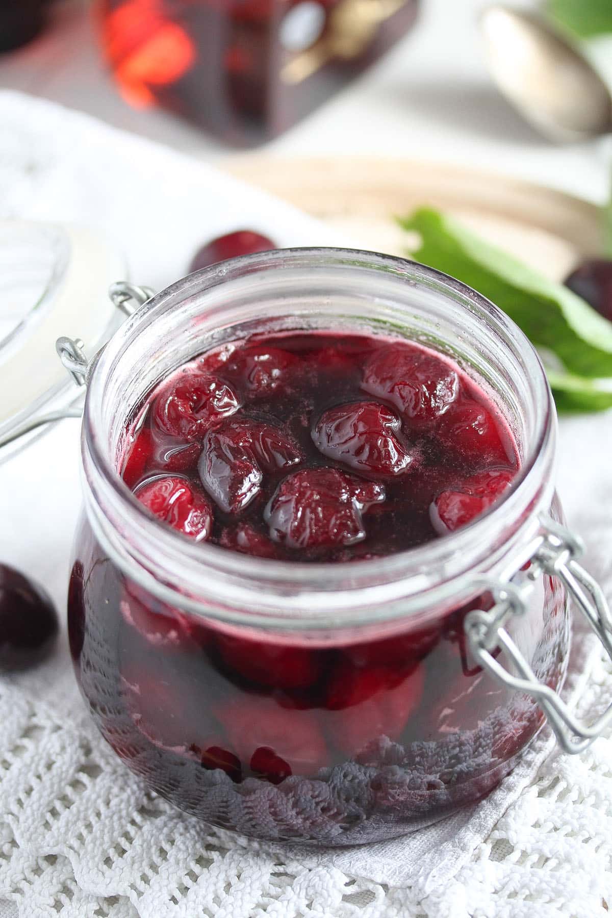 a jar full of cherries cooked in amaretto.