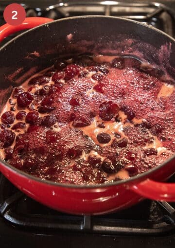 cooking cherries with sugar in a large pot.