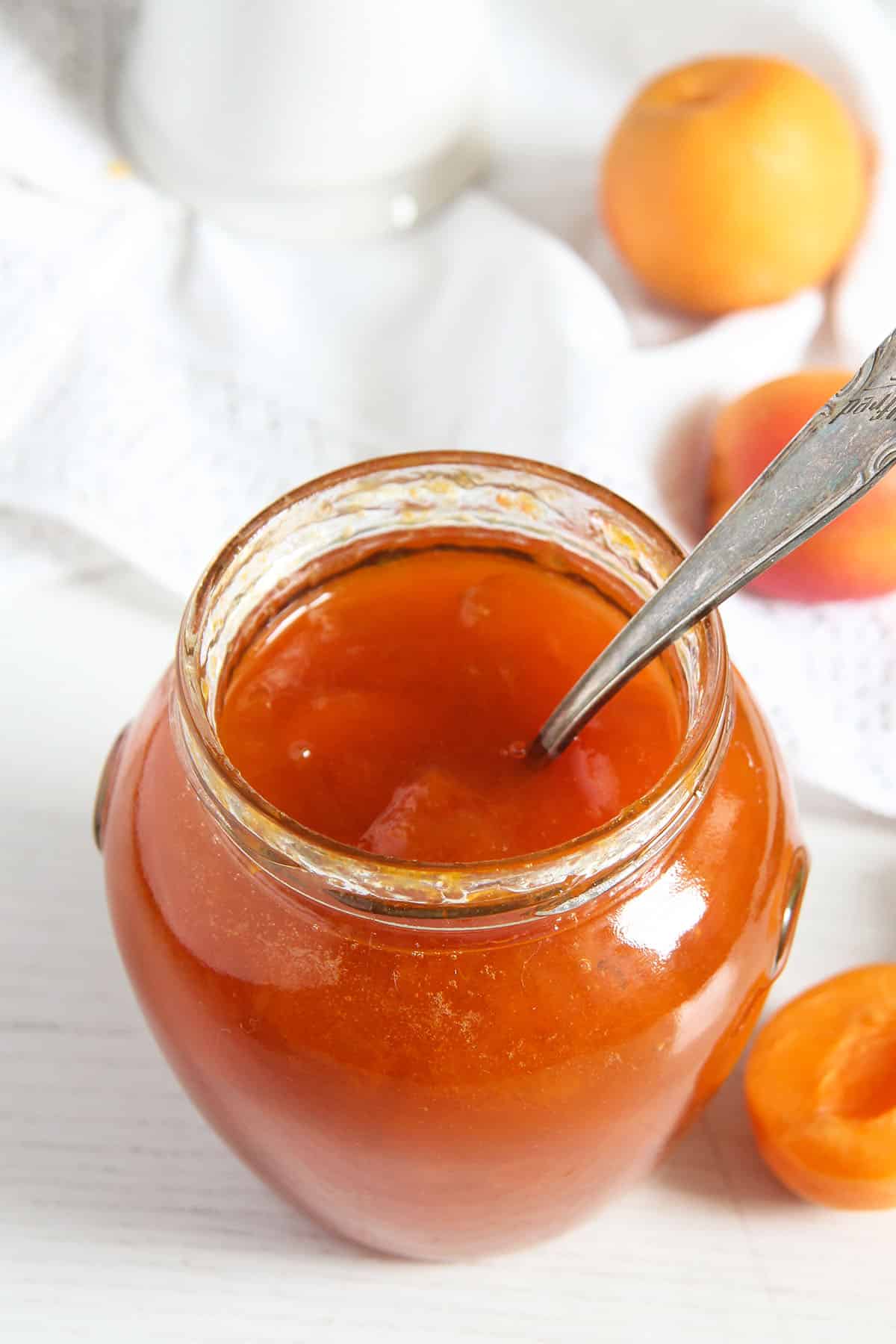 jar of apricot jam without pectin with a spoon in it.