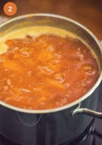 boiling apricot jam in a large pot.