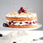 english bakewell sponge cake with cherries on a vintage platter.