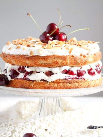 english bakewell sponge cake with cherries on a vintage platter