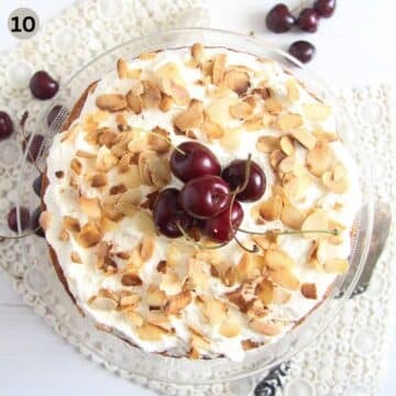 bakewell cake decorated with roasted almond flakes and cherries.