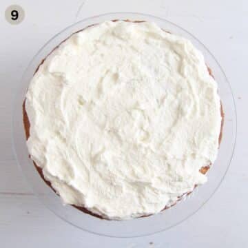 adding cream to the top of cherry bakewell cake.