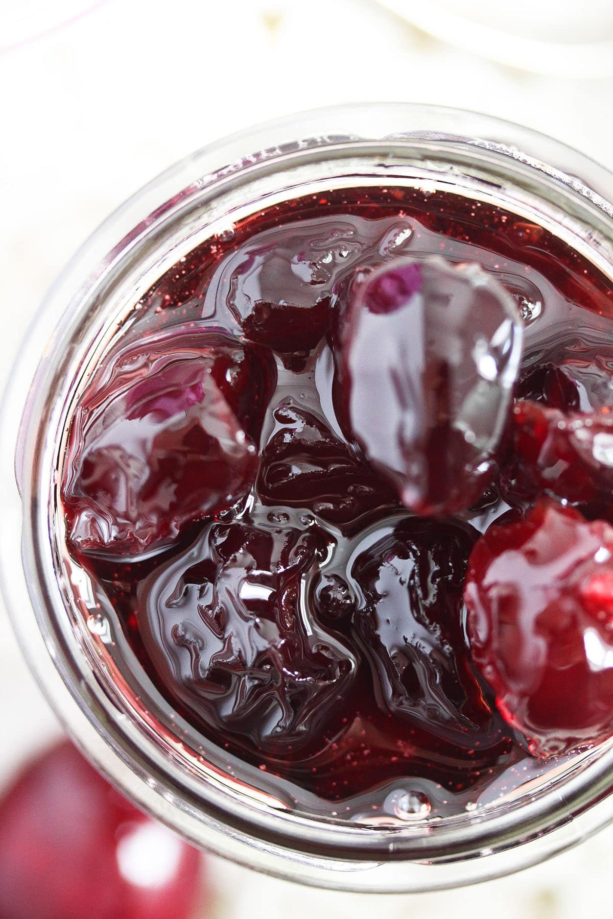 incredibly glossy, jewel-like candied cherries in a jar.