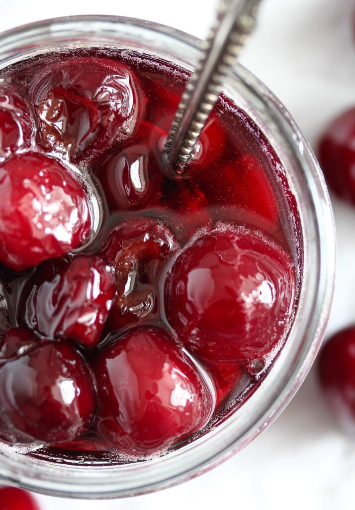 preserved cherries in juice and sugar in a small jar