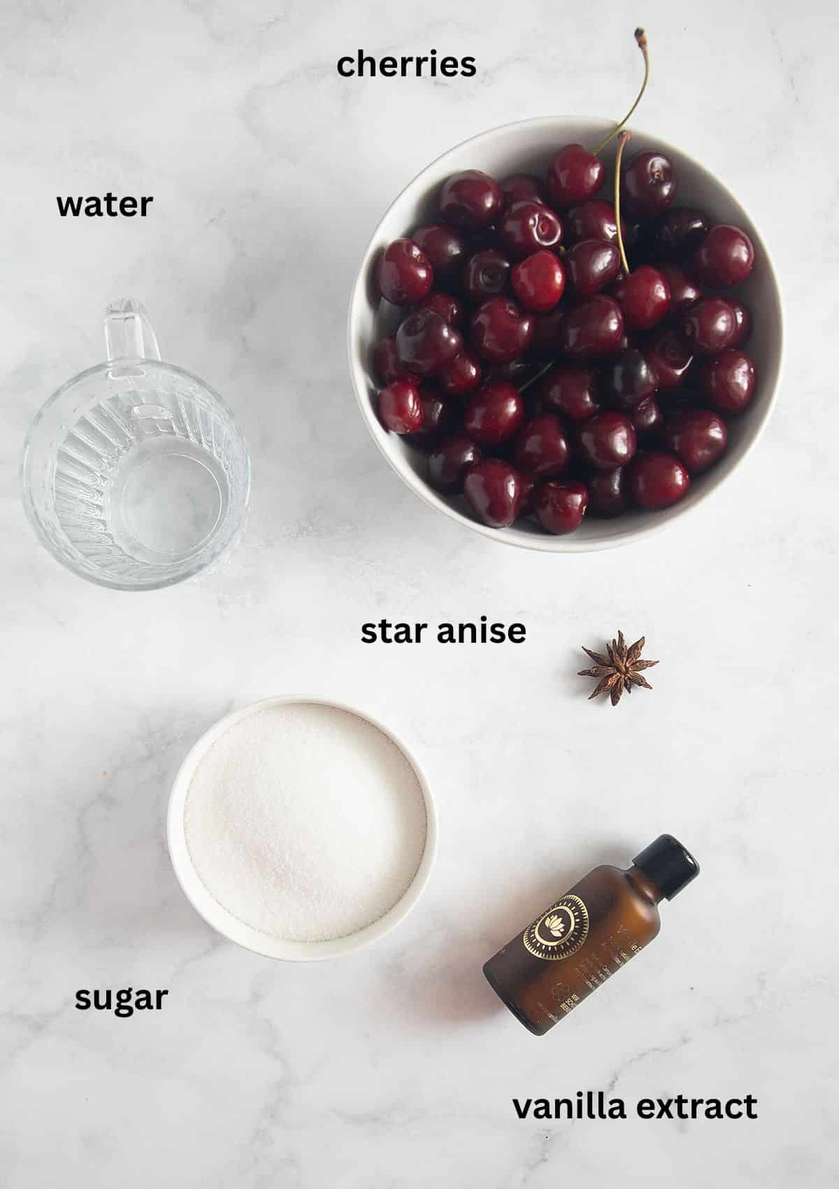 labeled ingredients for making cherries in syrup with sugar, vanilla extract, star anise and water.