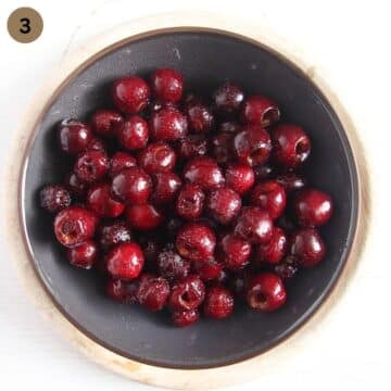 strained marinated cherries on a plate.