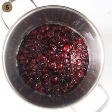 cooking cherries in syrup in a large pot.