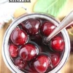 jar of shiny cherries with a spoon in it