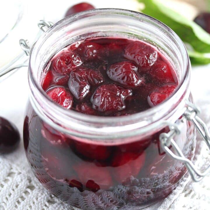 glossy amaretto cherries in a small jar