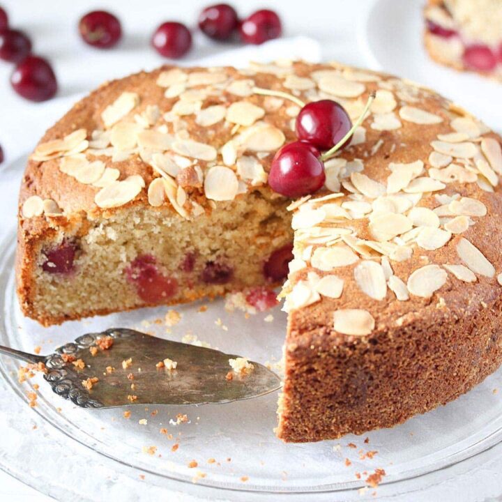 cherry and almond cake on a cake platter