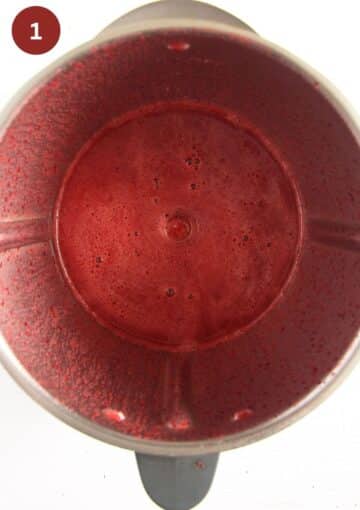 blended cherries, honey and lemon for making popsicles in a food processor.