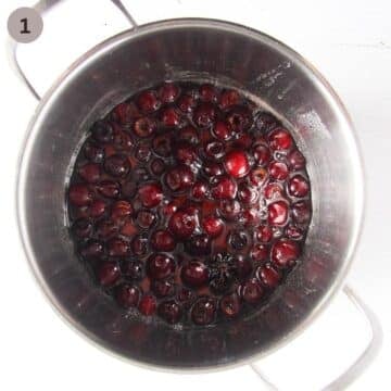 cherries simmering with lemon juice, water and sugar in a large pot.