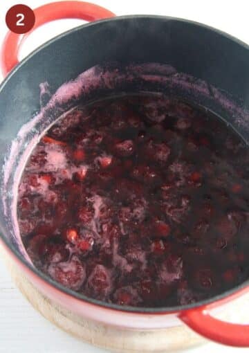 cooking cherries in vinegar in a large dutch oven to make cherry vinegar.