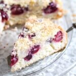 coconut and cherry cake slice being served.