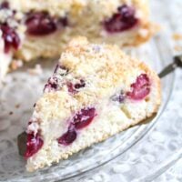 coconut and cherry cake slice being served.