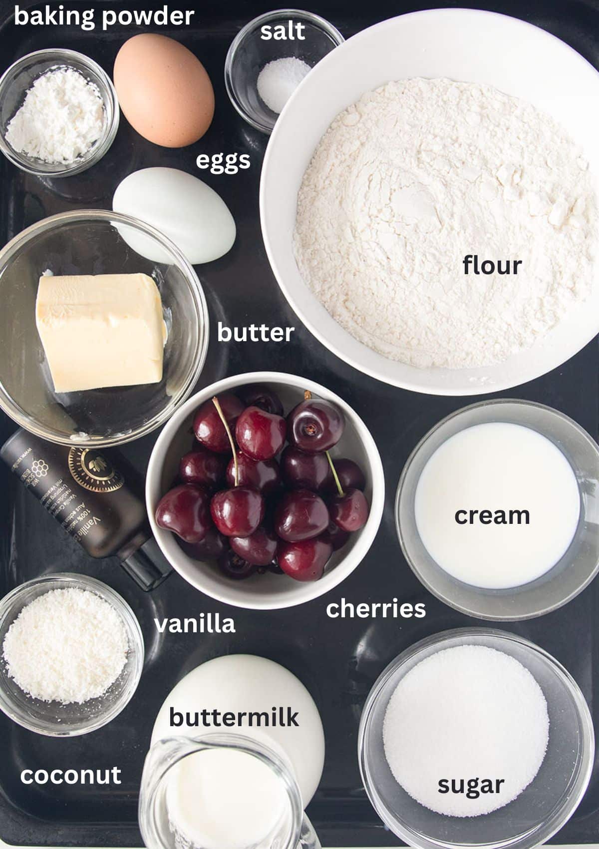 labeled ingredients for making cake with cherries and coconut.