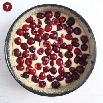 adding fresh cherries to cake batter in a springform.