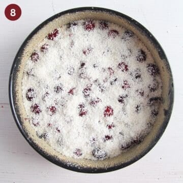 adding coconut to cherry cake batter in a springform.