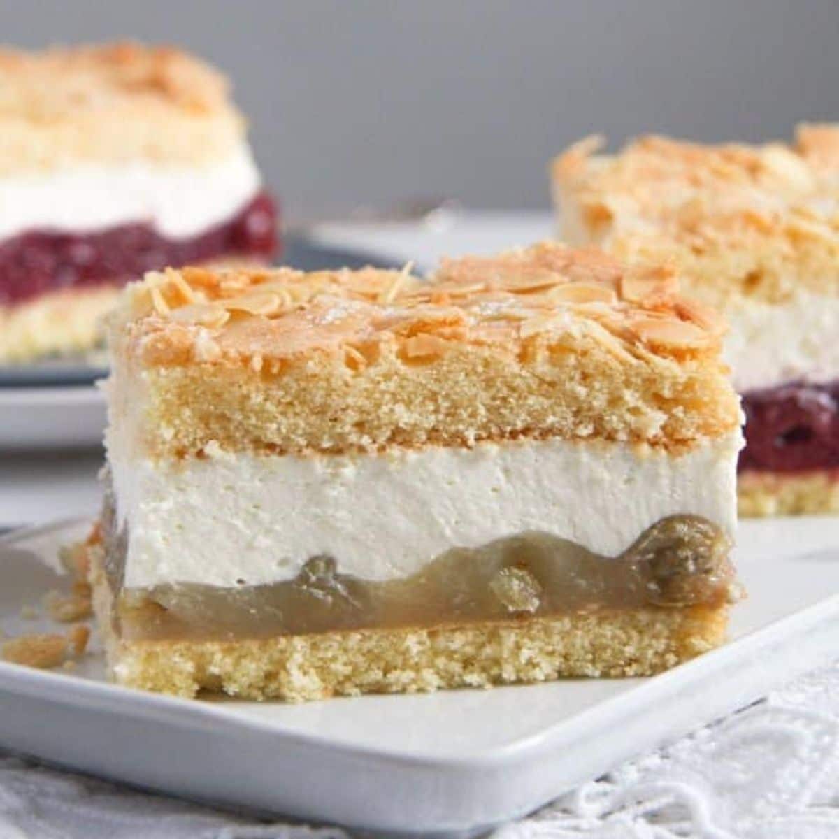 a rectangular piece of german gooseberry cheesecake on a platter.