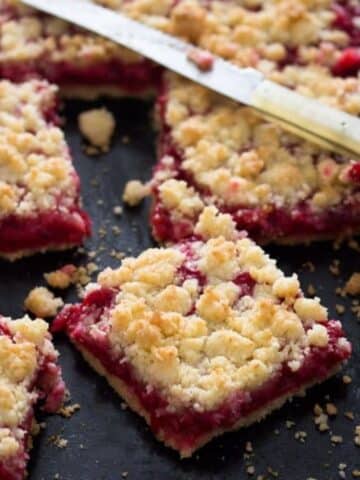 german red currant cake squares and a small knife.