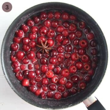cherries and a star anise in a large saucepan after cooking.