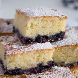 stapled pieces of fluffy lemon sour cream blueberry cake.