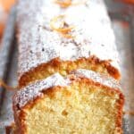 pinterest image of sliced loaf sprinkled with icing sugar on a vintange platter.