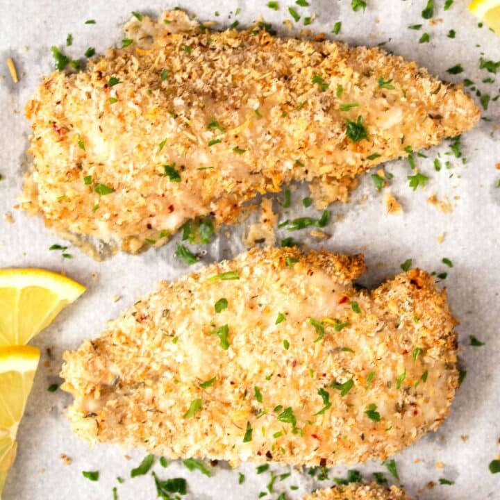 panko chicken without egg on a white baking sheet.