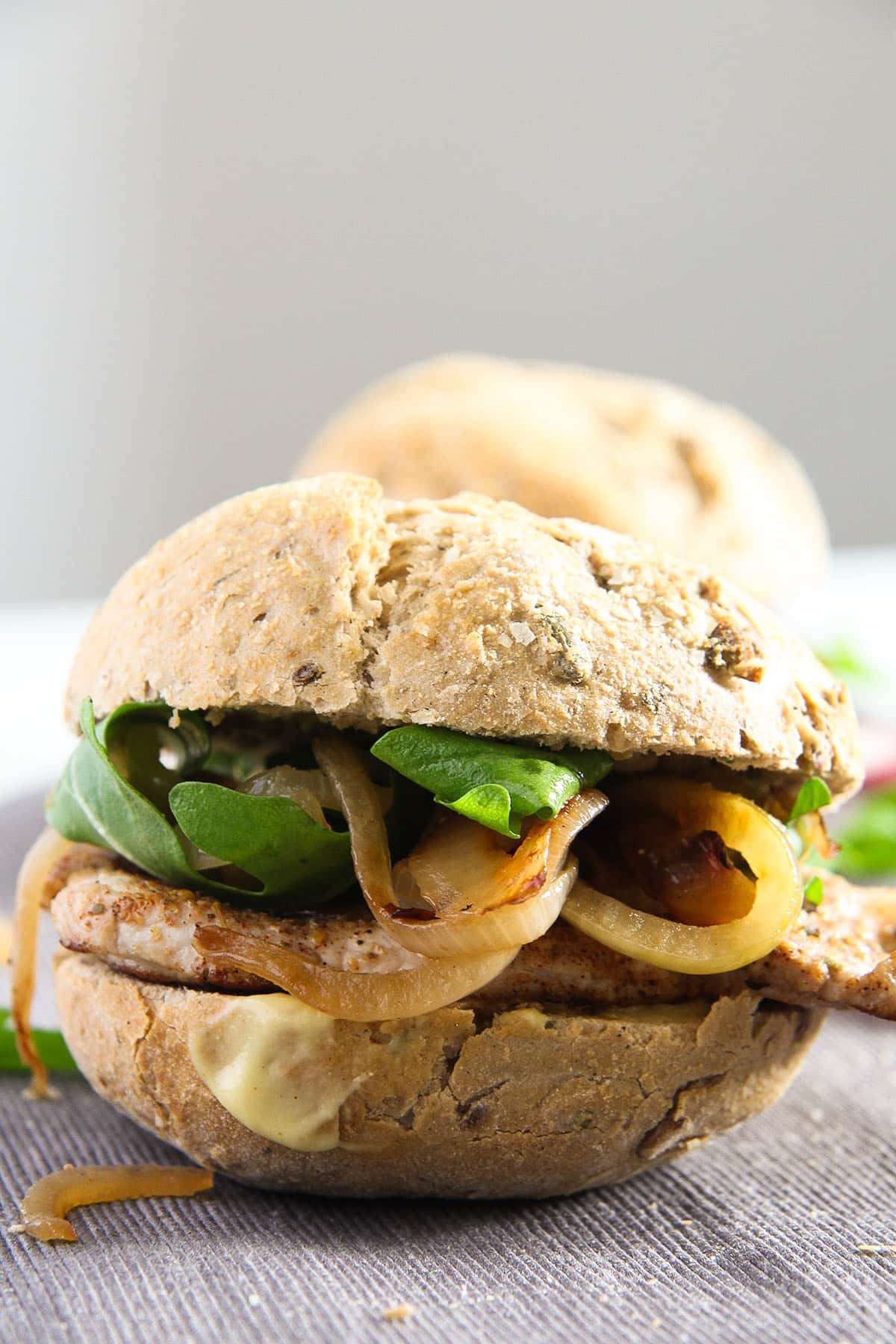 one pork burger with steak, caramelized onions and wholegrain bun.