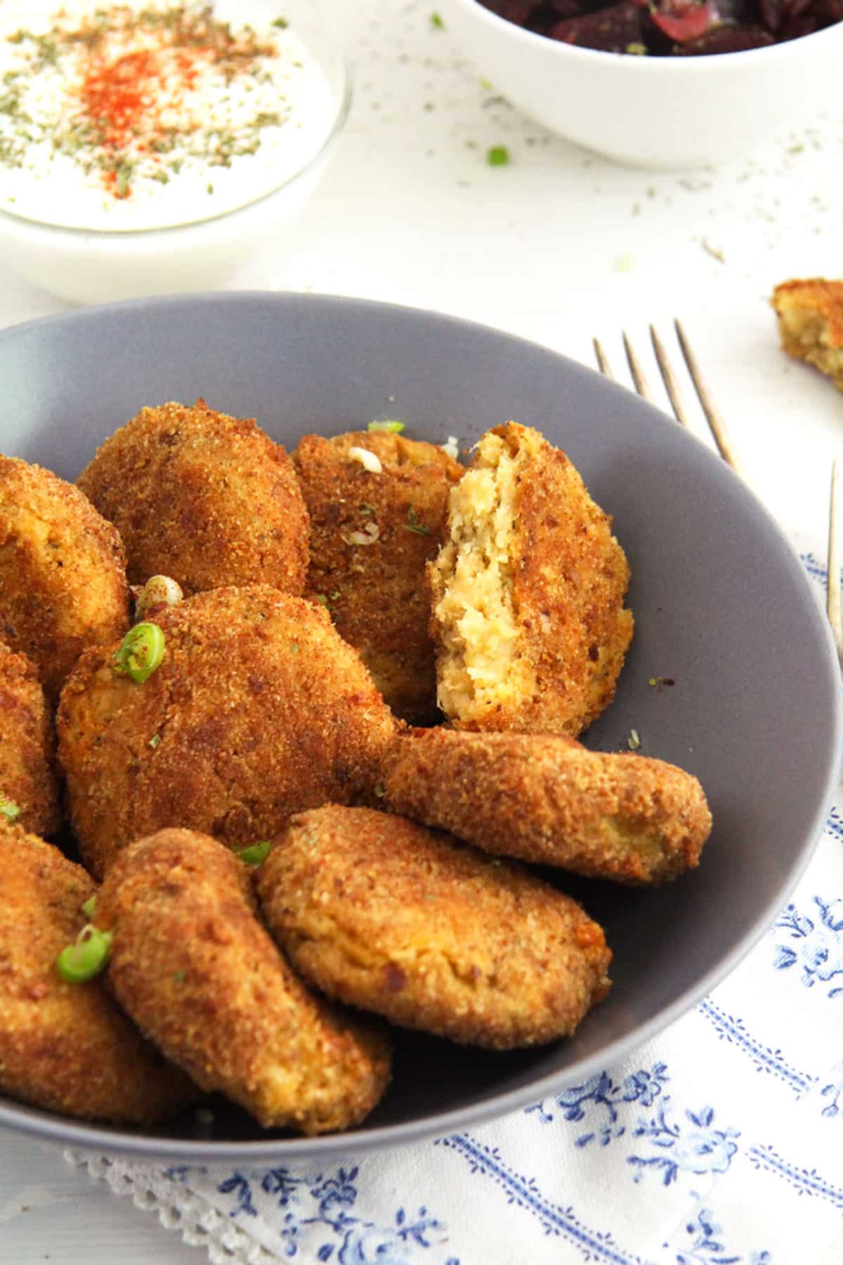 crispy baked potato and cauliflower patties in a bowl.