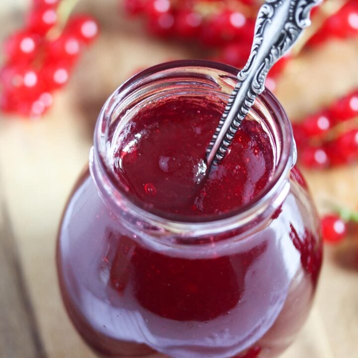 jelly or jam in a small jar on a wooden board
