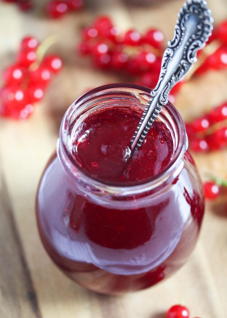 jelly or jam in a small jar on a wooden board
