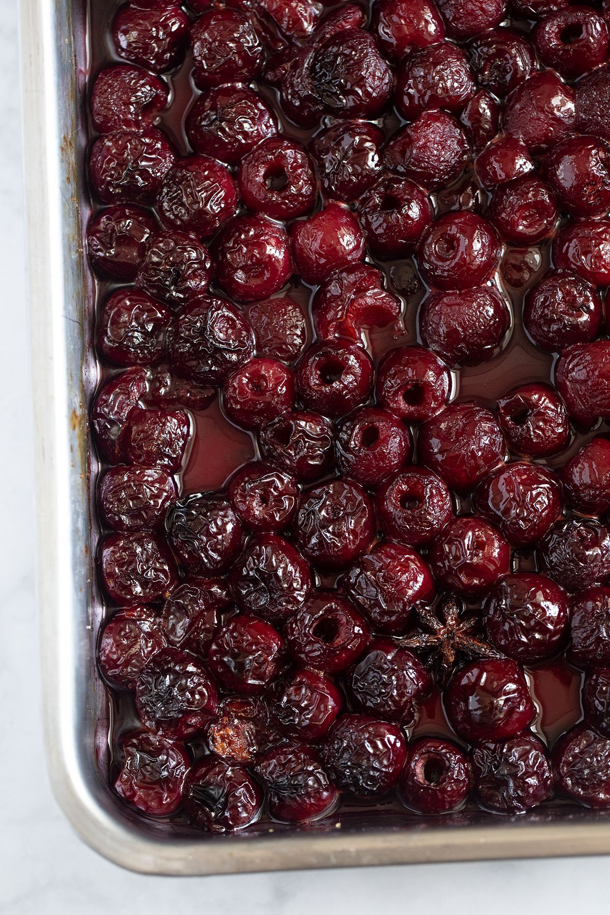 a roasting pan full of juicy roasted cherries.
