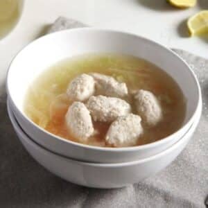 salmon stock served with fish dumplings in a bowl.