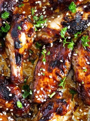 sweet and spicy chicken wings sprinkled with sesame seeds.