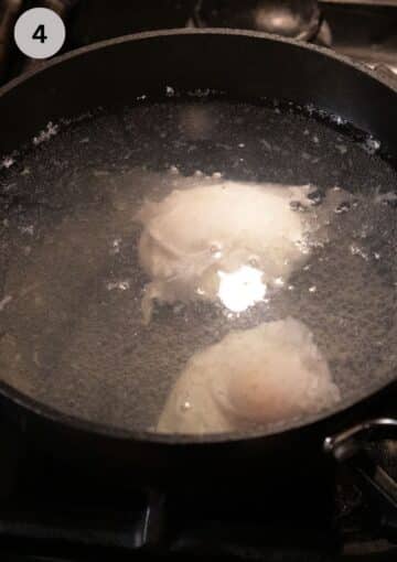 two eggs poaching in a saucepan full of simmering water.